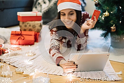 Out of focus smiling woman holding on focus tablet Stock Photo