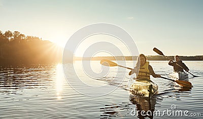 Out on the water where we love to be. a young couple kayaking on a lake outdoors. Stock Photo