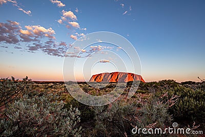 Outback, Australia - November 12, 2022: Sunrise at the Majestic Uluru or Ayers Rock at in the Northern Territory, Australia. The Editorial Stock Photo