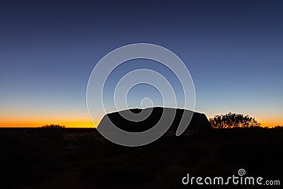 Outback, Australia - November 12, 2022: Sunrise at the Majestic Uluru or Ayers Rock in the Northern Territory, Australia. The red Editorial Stock Photo