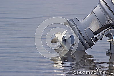 Outboard motor lowered into the water Stock Photo