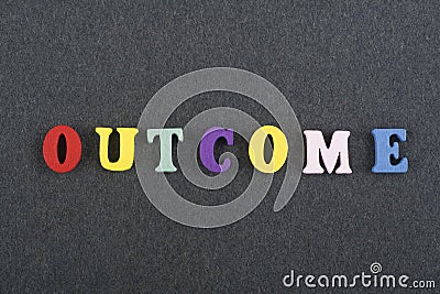 OUTCOME word on black board background composed from colorful abc alphabet block wooden letters, copy space for ad text. Learning Stock Photo