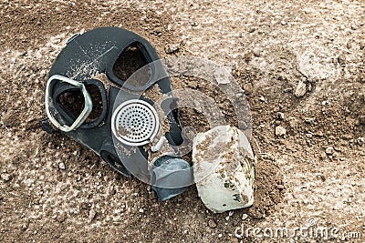 An outdated broken army gas mask is lying Stock Photo