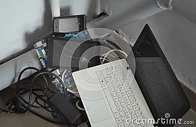 Outdated, broken gadgets piled in the corner of the room Editorial Stock Photo