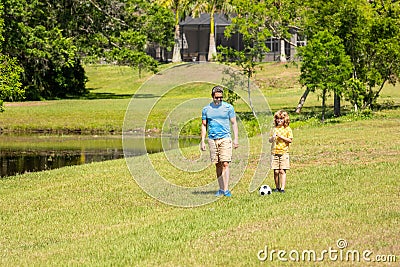 Outdoor adventures of daddy and son fatherhood together. football family team of father and son. Fatherhood in outdoor Stock Photo