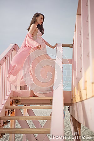 Beautiful pregnant woman on the lifeguard tower Stock Photo