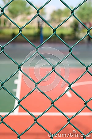 outdoor basketball court behind metal fence vertical composition Stock Photo