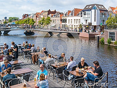 Outdoor cafe and bridge over Rhine canal, Leiden, Netherlands Editorial Stock Photo