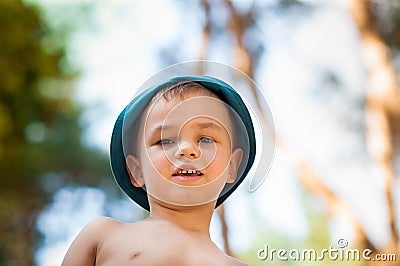 Outdoor close up portrait of little boy in a hat . Background, one person, child, 4-5 years old, happy smilling. Stock Photo