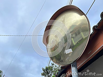 Outdoor convex safety mirror hanging on metal post Stock Photo