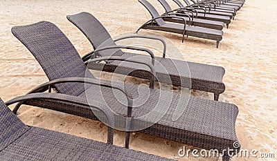 Outdoor daybed chairs lined up on the beach Stock Photo