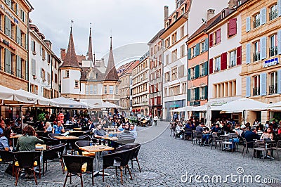 Outdoor dinning at Market place des Halles in Medieval town Neuchatel, Switzerland Editorial Stock Photo