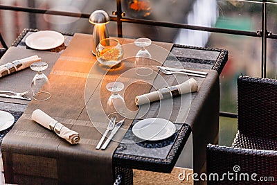 Outdoor dinning table set including plate, cutlery, napkin and wine glass Stock Photo