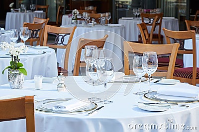 Outdoor elegant restaurant tables and chairs in summer Stock Photo