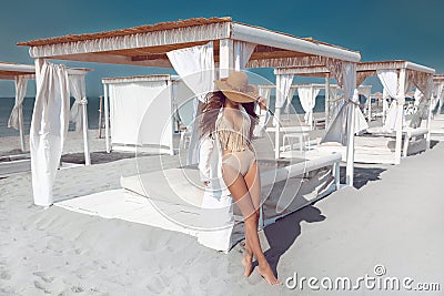 Outdoor fashion photo of bikini model in straw hat on tropi Stock Photo