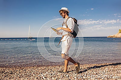 Handsome stylish tourist guy posing at the beach Stock Photo