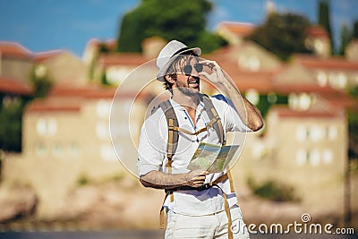 Portrait of handsome stylish tourist man posing at the beach Stock Photo