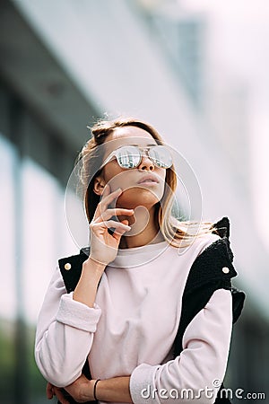 Outdoor fashion portrait of stylish hipster cool girl wearing sunglasses Stock Photo