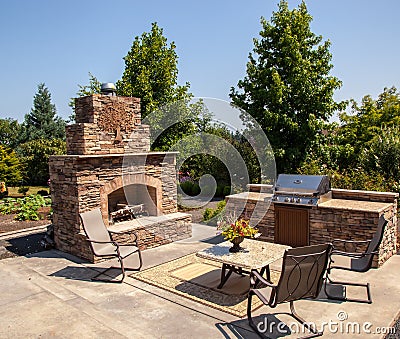 Outdoor fireplace and kitchen area Summer Stock Photo