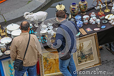 outdoor flea market in Paris set up on tables at the edge of the Seine. Editorial Stock Photo