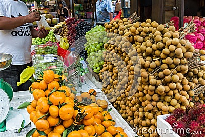 Outdoor fruit market with many different Asian organic fresh fruits. Editorial Stock Photo