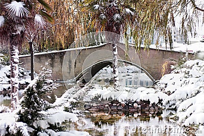 Outdoor garden and bridge with a dusting of snow. Winter Background. Snow Stock Photo