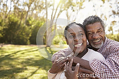 Outdoor Head And Shoulders Portrait Of Mature Couple In Park Stock Photo