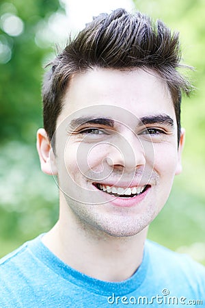 Outdoor Head And Shoulders Portrait Of Smiling Young Man Stock Photo