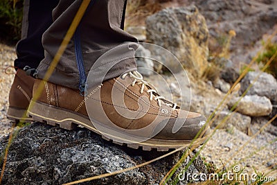 Outdoor hiking shoes on rock trail. Stock Photo
