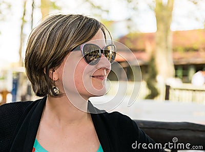 Outdoor holiday portrait of a happy thirty year old woman outdoors Stock Photo