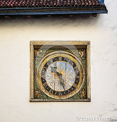 Outdoor medieval clock on the wall of the church of the Holy Ghost in Tallinn, Estonia Editorial Stock Photo