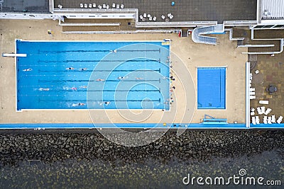 Outdoor open air swimming pool starts lessons for senior elderly and disabled swimmers aerial view from above Editorial Stock Photo