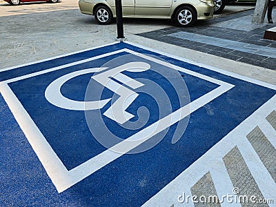 Outdoor parking space for people with disabilities, fairness and equality concept. Stock Photo
