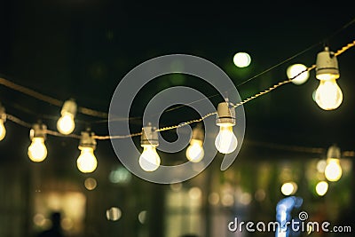 Outdoor party string lights glowing at night Stock Photo