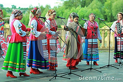 Outdoor performance of women singers wearing ukrainian ethnic traditional clothes and celebrating pagan holiday of Ivan Kupala Editorial Stock Photo