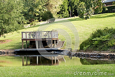 Outdoor platform and table overlooking a dam on a luxury country estate Stock Photo