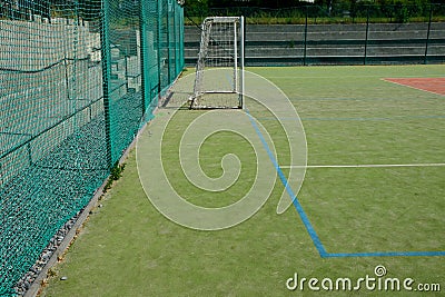 Outdoor playground for ball games. high barriers fencing protect spectators on a concrete tribune in the shape of stairs. Amphiree Stock Photo