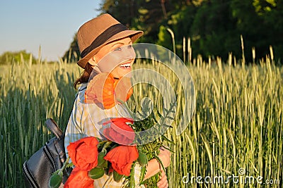 Outdoor portrait of a happy mature woman with bouquets of red poppies flowers Stock Photo