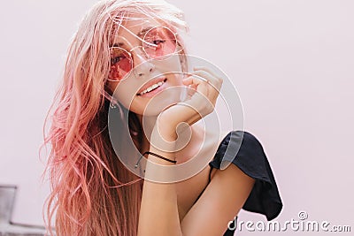 Outdoor portrait of inspired european woman with pink hair. Photo of lovely female model wears eleg Stock Photo