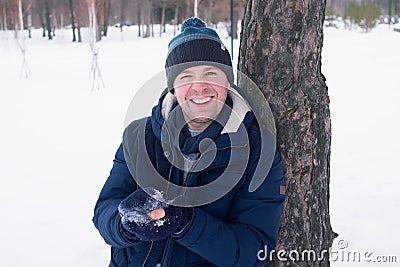 Outdoor portrait of smiling handsome man in coat and scurf Stock Photo