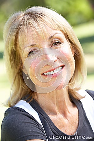 Outdoor Portrait Of Smiling Senior Woman Stock Photo