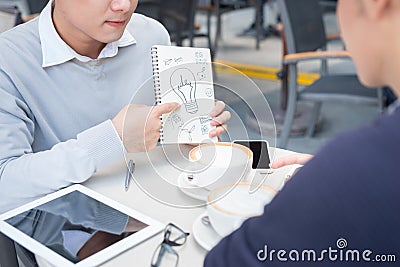 Outdoor portrait of two young entrepreneurs working at coffee sh Stock Photo