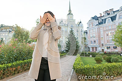 Outdoor portrait of a young woman covering her eyes Stock Photo