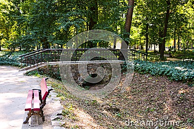 Outdoor recreation outdoor park with benches and bridge in spring Stock Photo