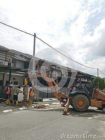 Outdoor scene of workers digging and piling concrete pole preparation for 5G cable connection Editorial Stock Photo