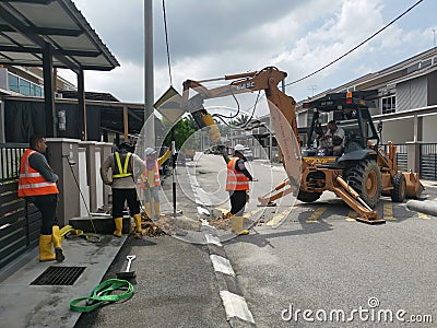Outdoor scene of workers digging and piling concrete pole preparation for 5G cable connection Editorial Stock Photo