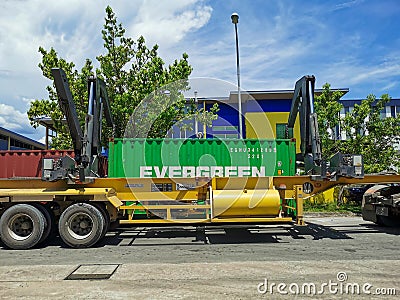 Outdoor scenery during day time with trailer truck unloading container. Editorial Stock Photo