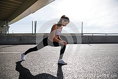 Outdoor shot of fitness model warming up legs Stock Photo