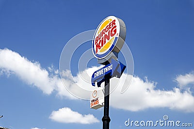 Outdoor signage of a popular international fast food restaurant on a clear sunny day Editorial Stock Photo