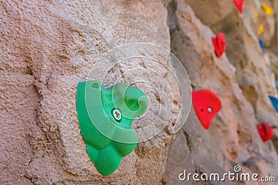 Outdoor sports climbing stone wall with multiple grips simulating mountain climbing, extreme hobby concept Stock Photo